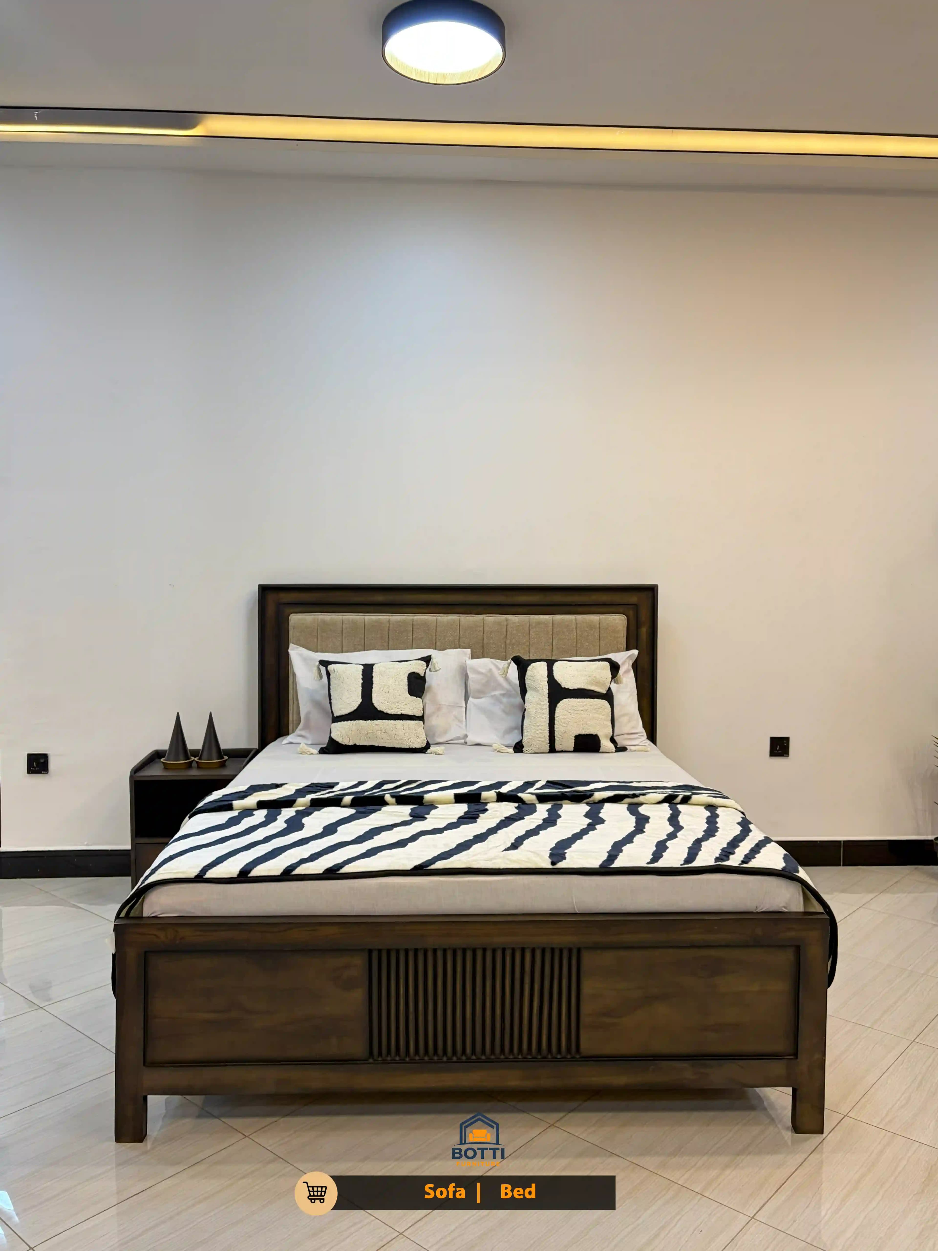 Serene master bedroom with a solid walnut bed frame and soft grey linens.
